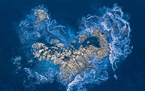 海浪冲击着悉尼海岸的一个心形岩石岛，澳大利亚 